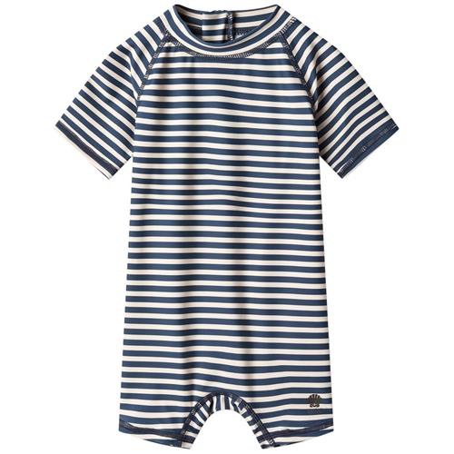 Se Wheat Cas Stribet UV-dragt Indigo | Marine blå | 92 cm ved Babyshop