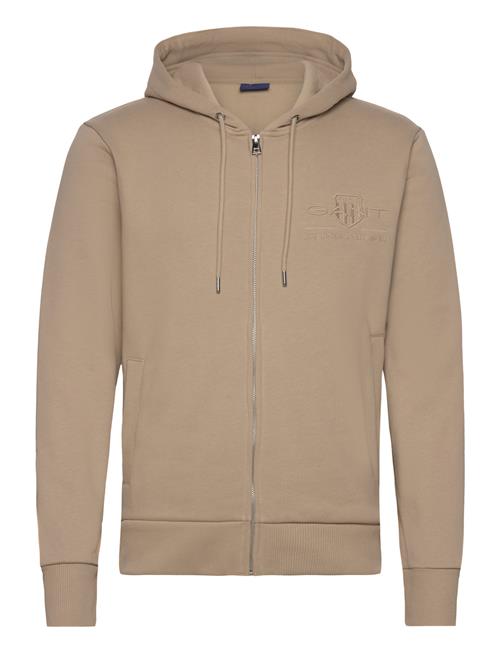 Se GANT Reg Tonal Shield Full Zip Hoodie GANT Beige ved Booztlet