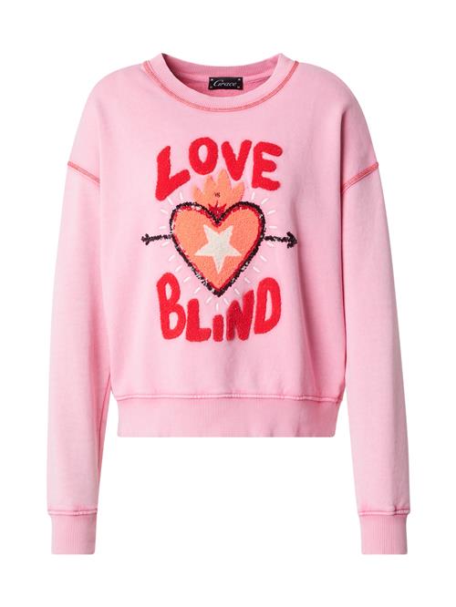 Se Grace Sweatshirt 'LOVE IS BLIND'  lyserød / rød / sort / hvid ved About You